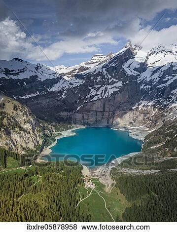 Stock Photo - Aerial view, Lake Oeschinen with snow-covered mountains, Kandersteg, Bernese Oberland, Switzerland, Europe. Fotosearch