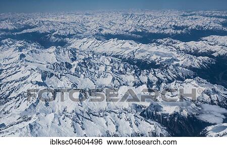Aerial view of snow-covered Alps, Austria, Europe View Large Photo Image Stock Photograph - Aerial view of snow-covered Alps, Austria, Europe. Fotosearch