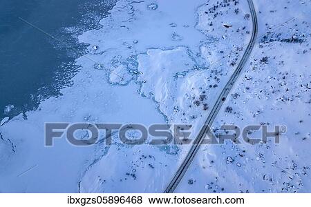 Aerial view, road with single car next to coast at sea, arctic, deep winter landscape, Nordland, Lofoten, Norway, Europe View Large Photo Image Stock Photo - Aerial view, road with single car next to coast at sea, arctic, deep winter landscape, Nordland, Lofoten, Norway, Europe. Fotosearch