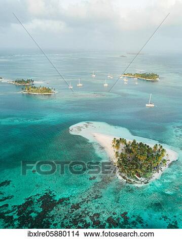 Picture - Aerial view, sailing boats between several small tropical palm islands, San Blas Islands. Fotosearch