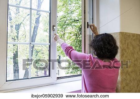 Stock Photo - Airing in a classroom, Teacher opens window to air, Austria, Europe. Fotosearch