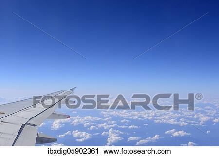 Airplane wing over a bright blue sky, United Kingdom, Europe View Large Photo Image Stock Image - Airplane wing over a bright blue sky, United Kingdom, Europe. Fotosearch