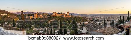 Stock Photo - Alhambra on the Sabikah hill at sunset, Moorish city castle, Nasrid palaces, Palace of Charlemagne, in the back Sierra Nevada with snow, panorama, Granada, Andalusia, Spain, Europe. Fotosearch