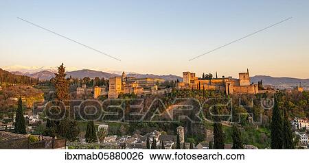 Stock Photograph - Alhambra on the Sabikah hill at sunset, Moorish citadel, Nasrid palaces, Palace of Charles the Fifth, behind Sierra Nevada with snow, Granada, Andalucia, Spain, Europe. Fotosearch