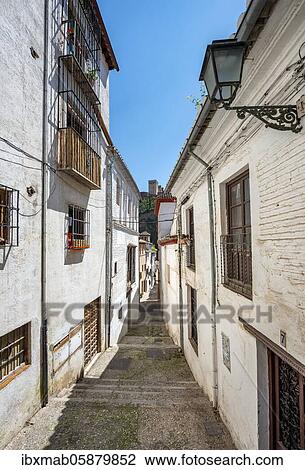 Stock Image - Alley with view of the towers of the Alhambra, Albaicín district, Granada, Andalusia, Spain, Europe. Fotosearch