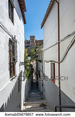 Stock Photo - Alley with view of the towers of the Alhambra, Albaicín district, Granada, Andalusia, Spain, Europe. Fotosearch