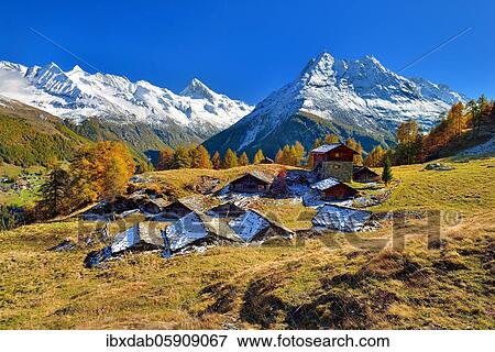 Alpine huts in Val d'Hérens, behind them snow-covered Valais Alps, Canton Valais, Switzerland, Europe View Large Photo Image Stock Photo - Alpine huts in Val d'Hérens, behind them snow-covered Valais Alps, Canton Valais, Switzerland, Europe. Fotosearch