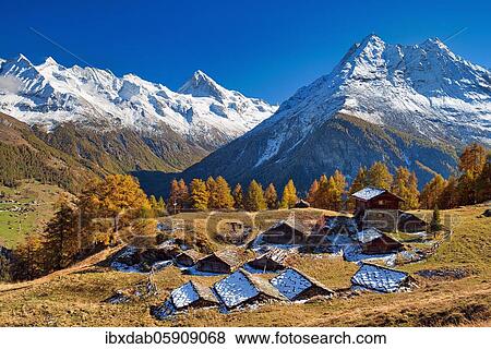 Alpine huts in Val d'Hérens, behind them snow-covered Valais Alps, Canton Valais, Switzerland, Europe View Large Photo Image Stock Photo - Alpine huts in Val d'Hérens, behind them snow-covered Valais Alps, Canton Valais, Switzerland, Europe. Fotosearch