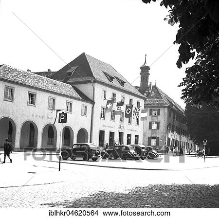 Picture - Approx. 1939, 1941, flag-raised building with the Fribourg Tourist Office and a travel agency.. Fotosearch