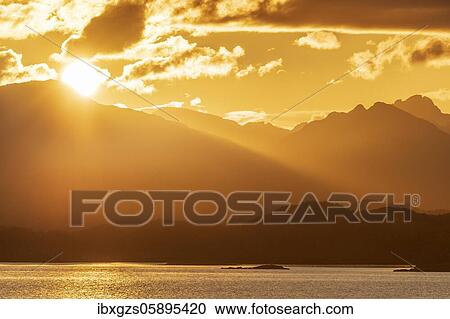 Atmospheric sunset over a high mountain range, in front sea, Bodø, Nordland, Norway, Europe View Large Photo Image Stock Image - Atmospheric sunset over a high mountain range, in front sea, Bodø, Nordland, Norway, Europe. Fotosearch
