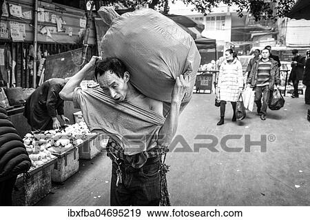 Bang-bang carriers in a market at the port of Chongqing, the carriers are like a caste of their own, carrying loads for the traders for little money, mostly immigrant workers from rural areas, Chongqing, China, Asia View Large Photo Image Stock Photo - Bang-bang carriers in a market at the port of Chongqing, the carriers are like a caste of their own, carrying loads for the traders for little money, mostly immigrant workers from rural areas, Chongqing, China, Asia. Fotosearch