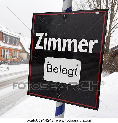 Stock Image - Black sign with the inscription Zimmer belegt, dreary winter weather, district Schierke, Wernigerode, Harz County, Saxony-Anhalt, Germany, Europe. Fotosearch