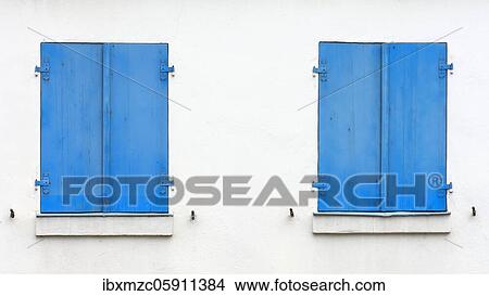 Picture - Blue shutters on white house, Bavaria, Germany, Europe. Fotosearch