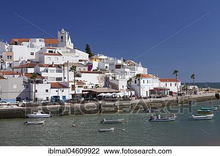 Stock Image - Boats in front of the fishing village of Ferragudo, near Portimao, Algarve, Portugal, Europe. Fotosearch