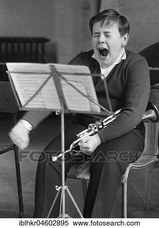 Stock Photography - Boy yawns, trumpet, England, Great Britain. Fotosearch