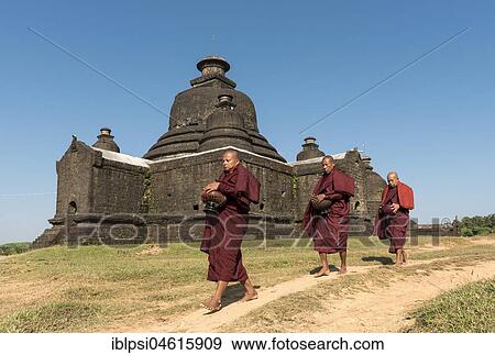 Buddhist monks collect morning alms in front of Laymyetnha Paya, Lemyethna Temple, Mrauk U, Burma, Myanmar, Asia View Large Photo Image Stock Photo - Buddhist monks collect morning alms in front of Laymyetnha Paya, Lemyethna Temple, Mrauk U, Burma, Myanmar, Asia. Fotosearch