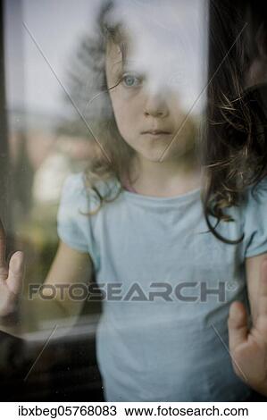 Child looks sadly through window pane View Large Photo Image Stock Image - Child looks sadly through window pane. Fotosearch