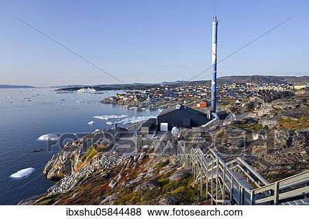 Stock Photo - City view with waste incineration plant at Disko Bay, in the foreground drift ice in the sea, lulissat, West Greenland, Greenland, North America. Fotosearch
