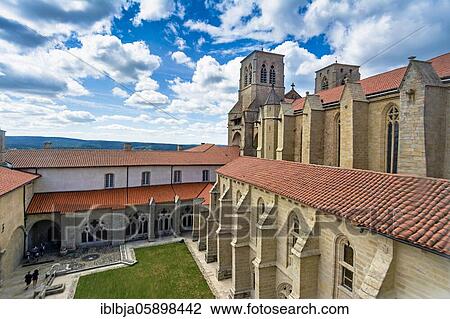 Stock Image - Cloister of the Saint Robert abbey, La Chaise Dieu, Haute Loire department, Auvergne-Rhone-Alpes, France, Europe. Fotosearch