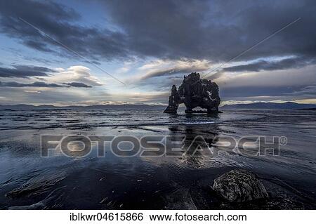 Stock Photograph - Cloudy atmosphere with reflection at Hvítserkur, basalt cliffs, Vatnsnes peninsula, Norðurland vestra, Northwest Iceland, Iceland, Europe. Fotosearch