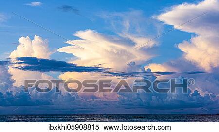 Cloudy sky over the sea, blue hour in the bay Beau Vallon, Mahe Island, Seychelles, Africa View Large Photo Image Stock Photography - Cloudy sky over the sea, blue hour in the bay Beau Vallon, Mahe Island, Seychelles, Africa. Fotosearch