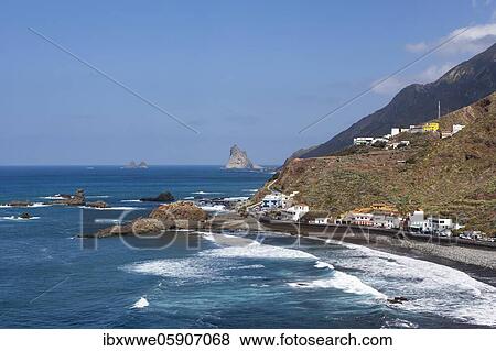 Stock Photo - Coastal road with cliffs in the Anaga Mountains with beach section Playa de Roque de las Bodegas near the township of Taganana, Almáciga, Tenerife, Canary Island, Spain, Europe. Fotosearch