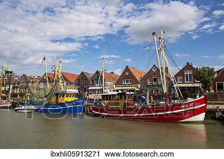 Stock Image - Colourful shrimp boats in the fishing port, Neuharlingersiel, East Frisia, Niedersachsen, Germany, Europe. Fotosearch