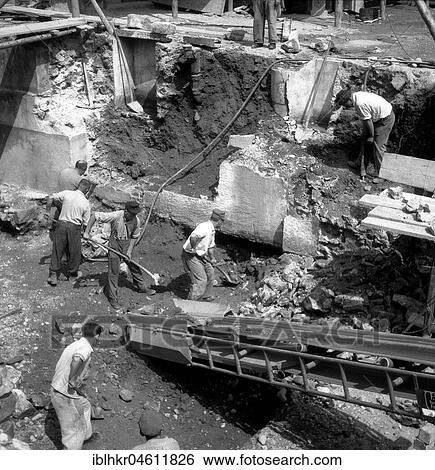 Construction workers shovel earth out of a hole, around 1950, Freiburg, Germany, Europe View Large Photo Image Stock Photograph - Construction workers shovel earth out of a hole, around 1950, Freiburg, Germany, Europe. Fotosearch