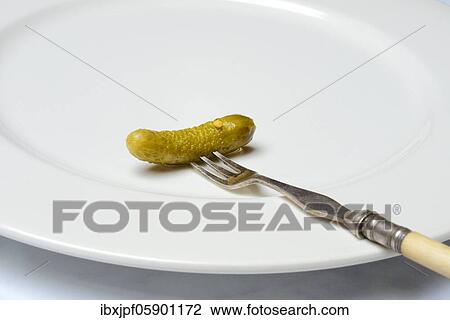 Cornichon, fork with cucumber on plate, Germany, Europe View Large Photo Image Stock Image - Cornichon, fork with cucumber on plate, Germany, Europe. Fotosearch
