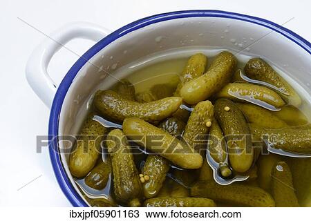 Stock Image - Cornichons, pickled gherkins in bowl, Germany, Europe. Fotosearch