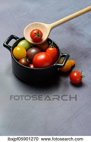 Different cherry tomatoes in pot with cooking spoon, Germany, Europe View Large Photo Image Stock Image - Different cherry tomatoes in pot with cooking spoon, Germany, Europe. Fotosearch