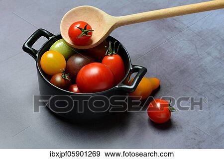 Different cherry tomatoes in pot with cooking spoon, Germany, Europe View Large Photo Image Stock Photo - Different cherry tomatoes in pot with cooking spoon, Germany, Europe. Fotosearch