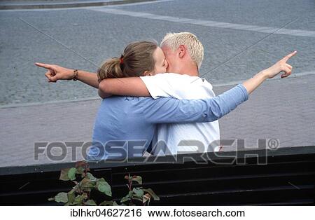 Stock Photograph - Different views, kissing couple shows in different directions, Berlin, Germany, Europe. Fotosearch