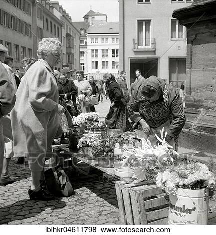 Elderly lady buys a bouquet of flowers, Freiburger Münstermarkt, around 1950, Freiburg, Germany, Europe View Large Photo Image Stock Photo - Elderly lady buys a bouquet of flowers, Freiburger Münstermarkt, around 1950, Freiburg, Germany, Europe. Fotosearch
