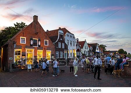 Stock Photo - Evening mood at the harbour promenade, Greetsiel, Krummhörn, East Frisia, Lower Saxony, Germany, Europe. Fotosearch