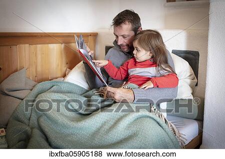 Father reading aloud with daughter, Bavaria, Germany, Europe View Large Photo Image Stock Photo - Father reading aloud with daughter, Bavaria, Germany, Europe. Fotosearch
