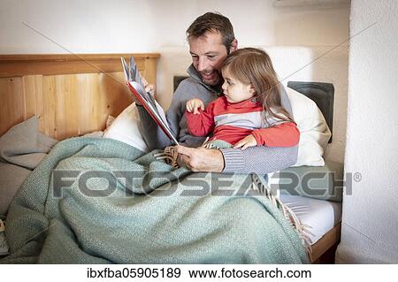 Father reading aloud with daughter, Bavaria, Germany, Europe View Large Photo Image Stock Photo - Father reading aloud with daughter, Bavaria, Germany, Europe. Fotosearch