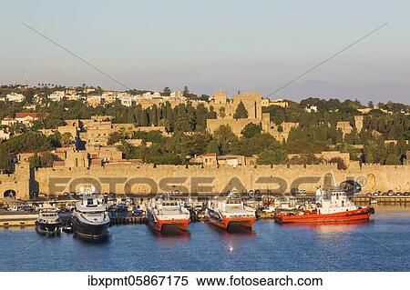 Ferry boats docked in commercial harbour and old town of Rhodes with fortification walls at sunrise, Rhodes, Greece, Europe View Large Photo Image Stock Photography - Ferry boats docked in commercial harbour and old town of Rhodes with fortification walls at sunrise, Rhodes, Greece, Europe. Fotosearch