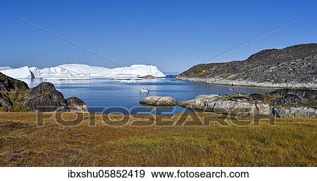 Fishermen with boat in front of gigantic icebergs, UNESCO World Natural Heritage, Ilulissat, Disko Bay, West Greenland, Greenland, North America View Large Photo Image Stock Photo - Fishermen with boat in front of gigantic icebergs, UNESCO World Natural Heritage, Ilulissat, Disko Bay, West Greenland, Greenland, North America. Fotosearch