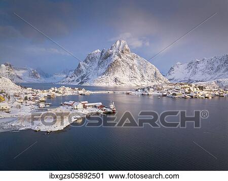 Stock Image - Fishing village Reine in winter at dawn, snowy landscape, Reinefjord, Moskenesøya, Nordland, Lofoten, Norway, Europe. Fotosearch