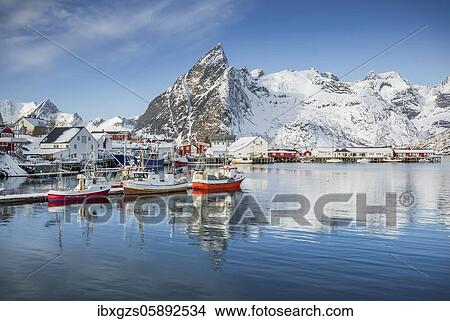 Picture - Fishing village with fishermen's cabins and jetty in winter by the fjord, Hamnoy, Nordland, Lofoten, Norway, Europe. Fotosearch