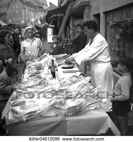 Stock Photograph - Frying pan salesman on a street in Freiburg, Freiburger Münstermarkt, approx. 1945 to 1955, Freiburg, Germany, Europe. Fotosearch