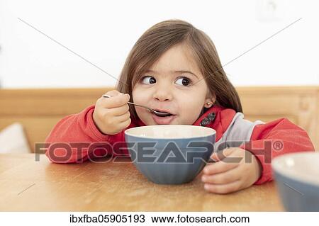 Stock Image - Girls, Breakfast with muesli, Bavaria, Germany, Europe. Fotosearch