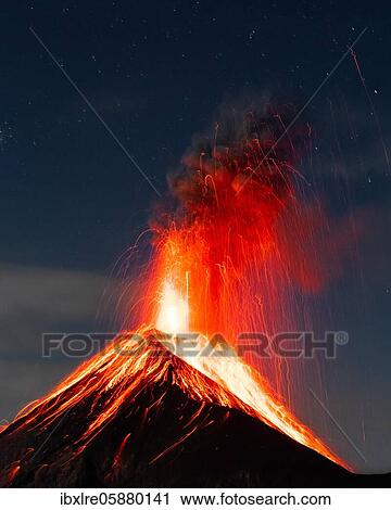 Stock Image - Glowing lava and smoke spitting volcano, volcanic eruption at night, Volcan de Fuego, Guatemala, Central America. Fotosearch