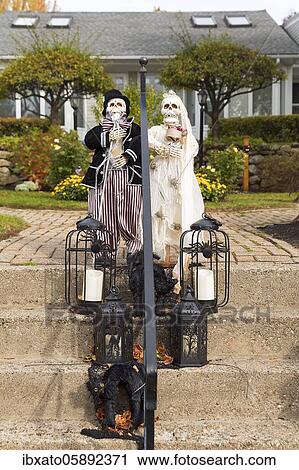 Stock Image - Halloween, decoration in front of a house, two skeletons, bridal couple, bride and groom standing on a staircase with lanterns, Ogunquit, York County, Maine, New England, USA, North America. Fotosearch
