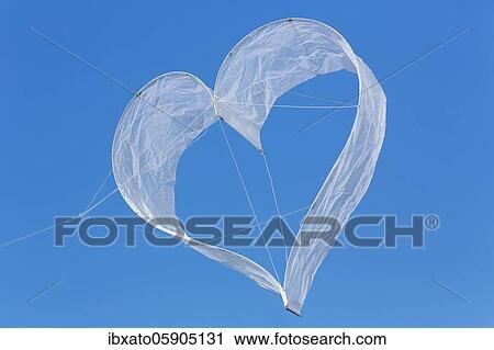 Stock Image - Heart-shaped dragon, white heart in front of blue sky, North Rhine-Westphalia, Germany, Europe. Fotosearch