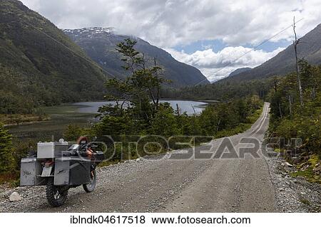 Stock Photo - Heavily packed motorcycle on a gravel road, O higgins, Region de Aysen, Chile, South America. Fotosearch