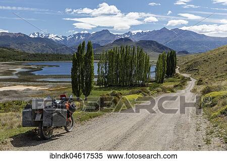 Heavily packed motorcycle on a gravel road in front of a lake, Valle Chacabuco, Cochrane, Region de Aysen, Chile, South America View Large Photo Image Stock Photography - Heavily packed motorcycle on a gravel road in front of a lake, Valle Chacabuco, Cochrane, Region de Aysen, Chile, South America. Fotosearch
