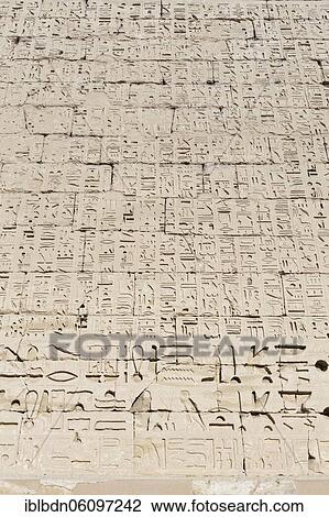 Stock Image - Hieroglypic carvings on wall at the ancient temple of Medinat Habu, Luxor, Egypt, Africa. Fotosearch