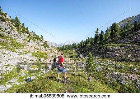 Hiker looks into the distance, in the back the summit of the Watzmann, hiking trail in the Funtenseetauern, Steinernes Meer, Berchtesgaden National Park, Berchtesgadener Land, Upper Bavaria, Bavaria, Germany, Europe View Large Photo Image Stock Photo - Hiker looks into the distance, in the back the summit of the Watzmann, hiking trail in the Funtenseetauern, Steinernes Meer, Berchtesgaden National Park, Berchtesgadener Land, Upper Bavaria, Bavaria, Germany, Europe. Fotosearch